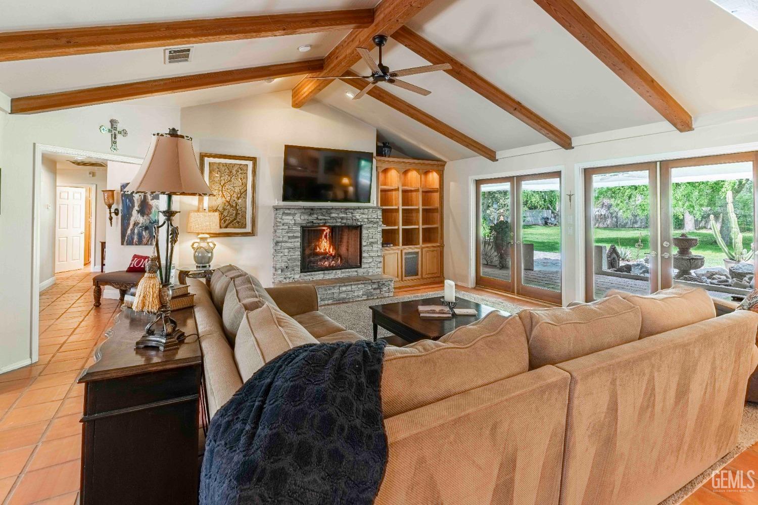 Undisclosed Address Bakersfield, CA 93314 - Photo 8 of 67 a living room with furniture a flat screen tv and a floor to ceiling window
