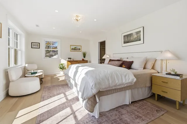 a spacious bedroom with a bed and couch