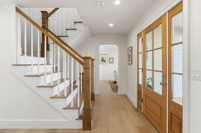 a view of entryway with wooden floor and stairs