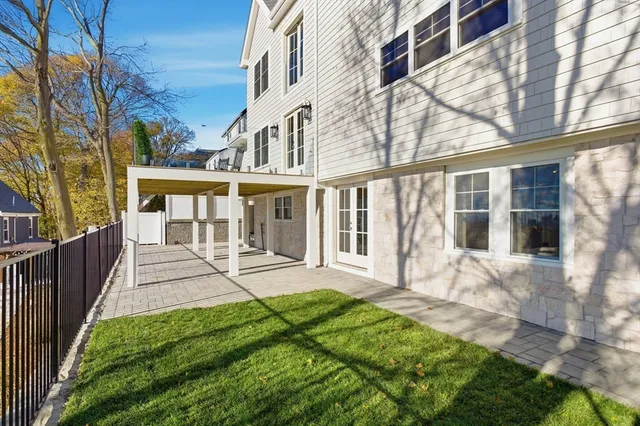 a view of a house with a yard and wooden fence