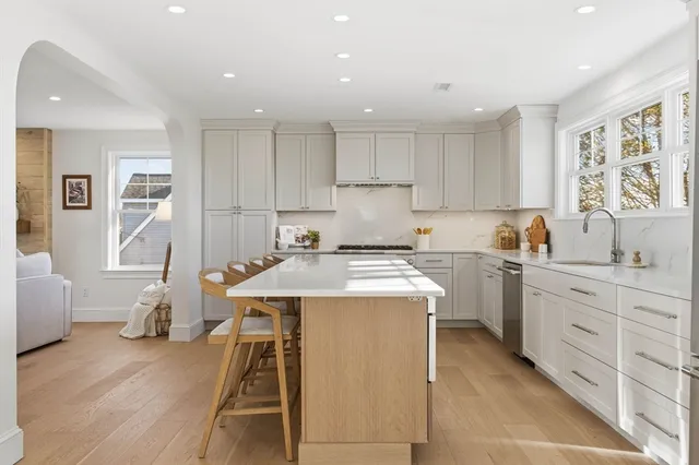 a kitchen with a sink window and cabinets