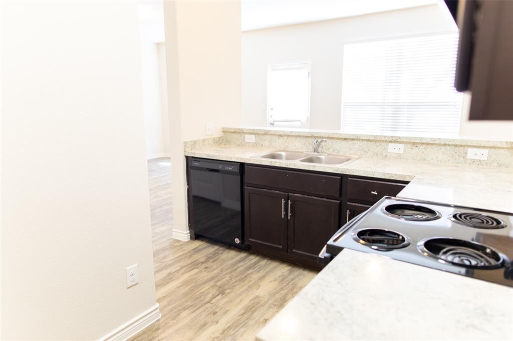 a kitchen that has a sink and a stove