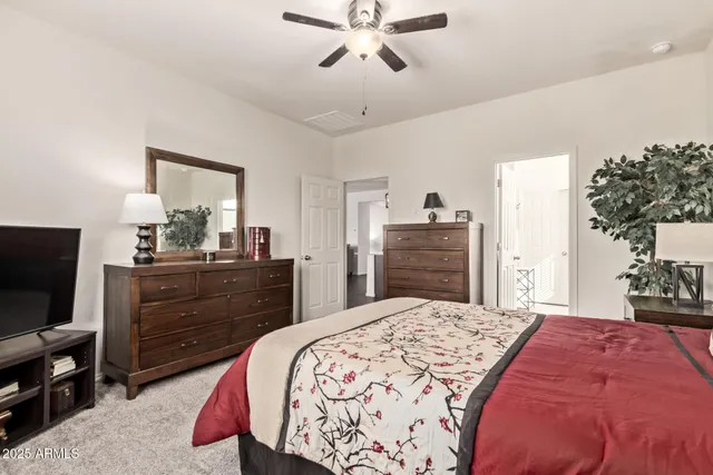 a bedroom with a bed and a dresser