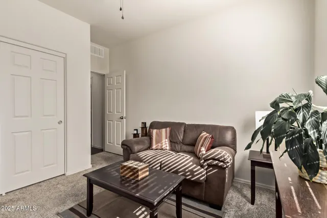 a living room with furniture and a potted plant