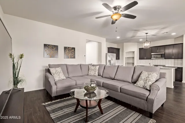 a living room with furniture and a chandelier