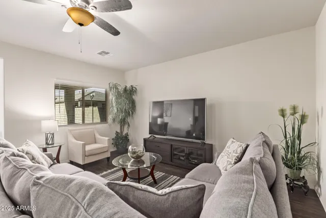 a living room with furniture and lamp