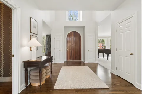 a view of hall way with furniture and a livingroom with wooden floor