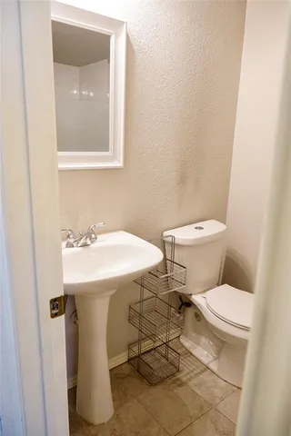 a bathroom with a sink toilet and mirror