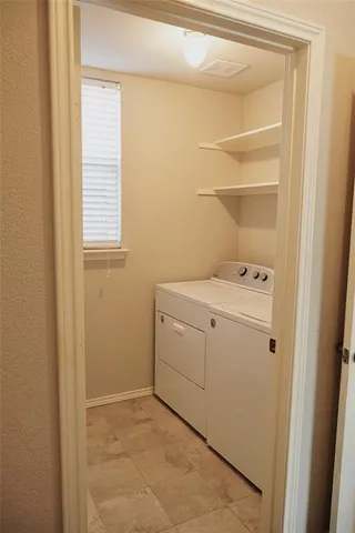 a utility room with washer and dryer