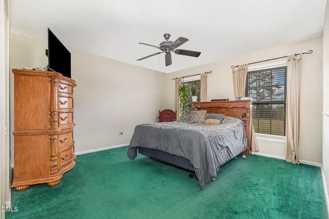 a bed room with a bed and a television