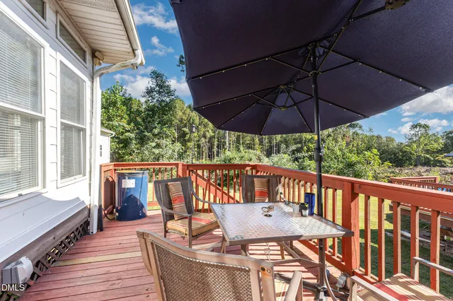 a view of balcony with furniture and umbrella
