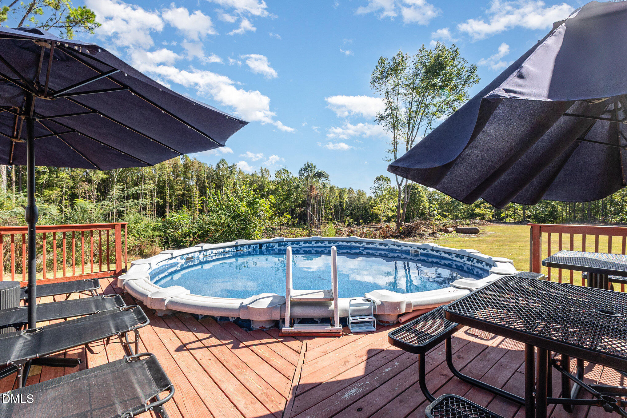 376-t K T K Allen Road Louisburg, NC 27549 - Photo 29 of 39 a patio with wooden floor a yard a table and chairs