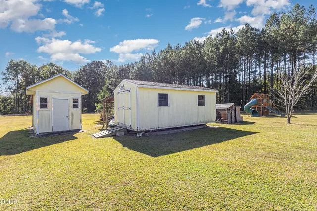 a view of a backyard with a large tree
