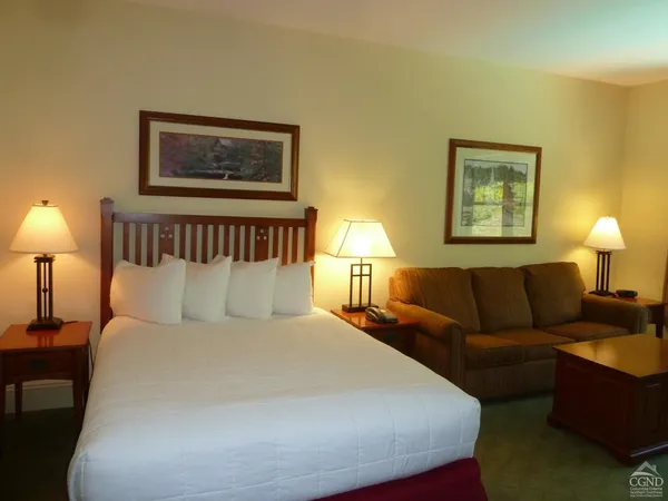 a bed room with a bed and a lamp