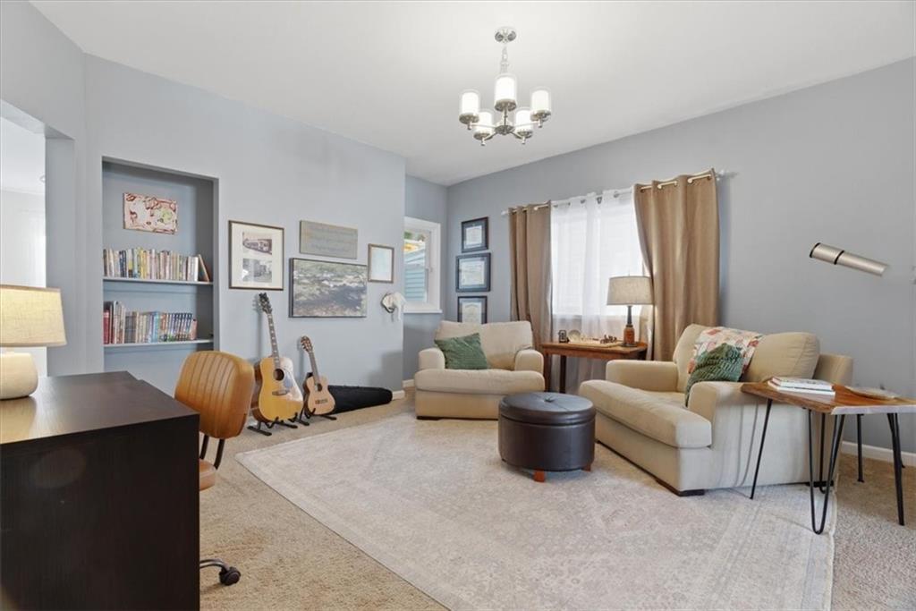 246 Dunseith Street Pittsburgh, PA 15213 - Photo 8 of 36 a living room with furniture and a chandelier