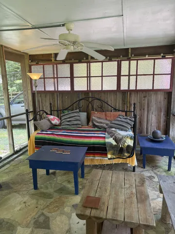 a bedroom with furniture and a floor to ceiling window