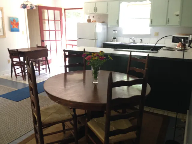 a kitchen with a table chairs and window
