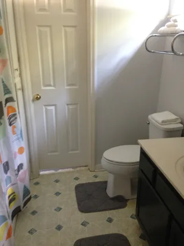 a bathroom with a toilet and shower
