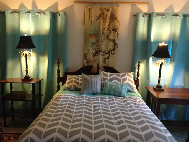 a bedroom with a bed and a mirror