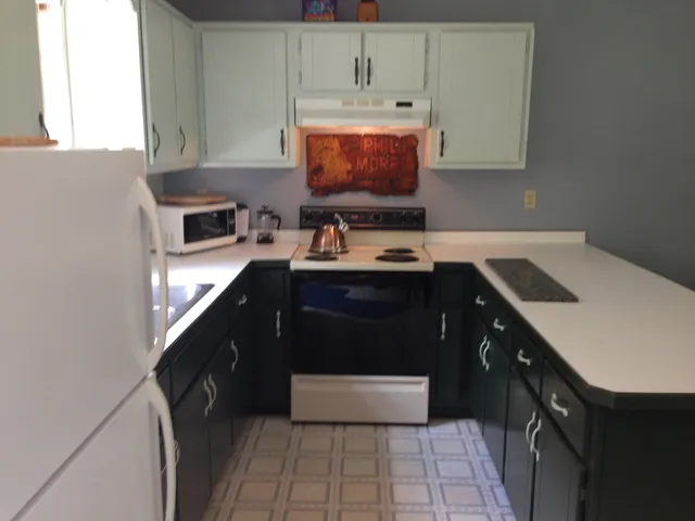 a kitchen with stainless steel appliances a stove a sink and a microwave