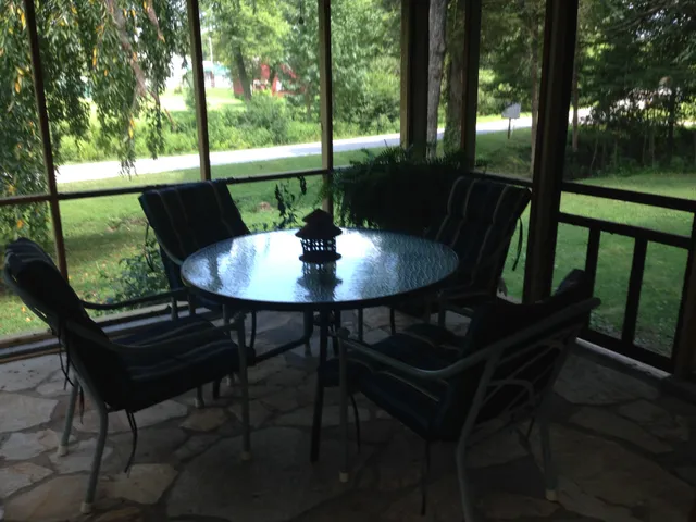 a view of a chairs and table in the patio