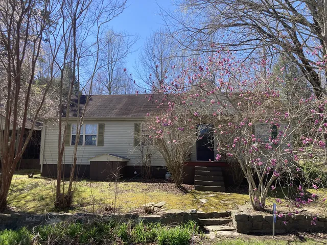 a view of a house with a yard covered in snow