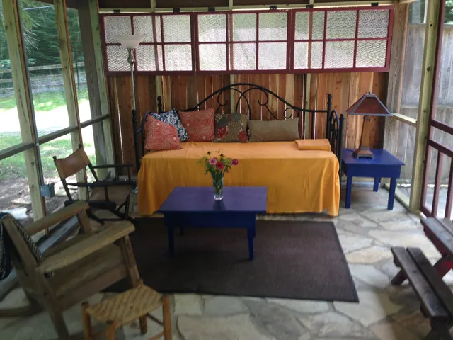 a bed sitting in a bedroom next to a window