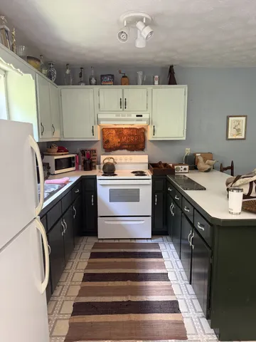 a kitchen with a sink stove and cabinets