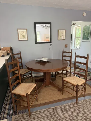 a reading room with furniture a rug and a window