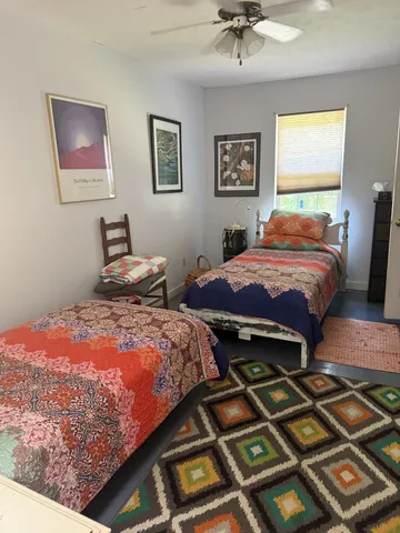 a bedroom with bed and a chandelier