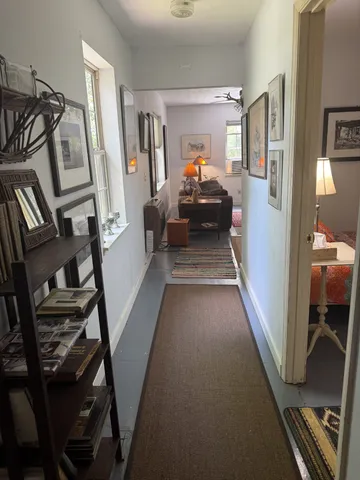 a view of a hallway with furniture and stairs