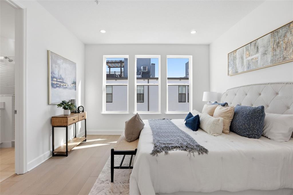 2174 Whitney Marsh Alley Orlando, FL 32804 - Photo 17 of 50 a bedroom with a large bed and a window