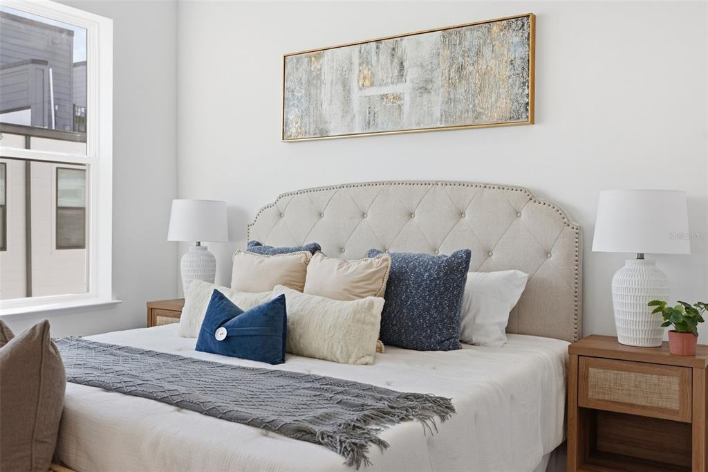 2174 Whitney Marsh Alley Orlando, FL 32804 - Photo 18 of 50 a large bed sitting in a bedroom next to a window with potted plant