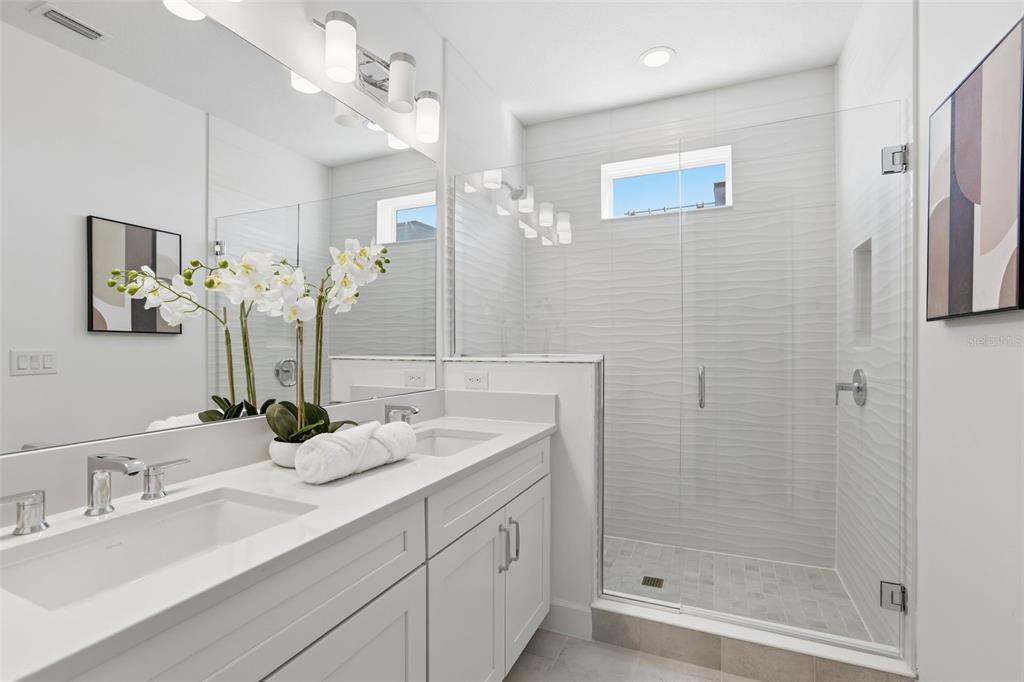 2174 Whitney Marsh Alley Orlando, FL 32804 - Photo 20 of 50 a bathroom with a double vanity sink mirror and shower