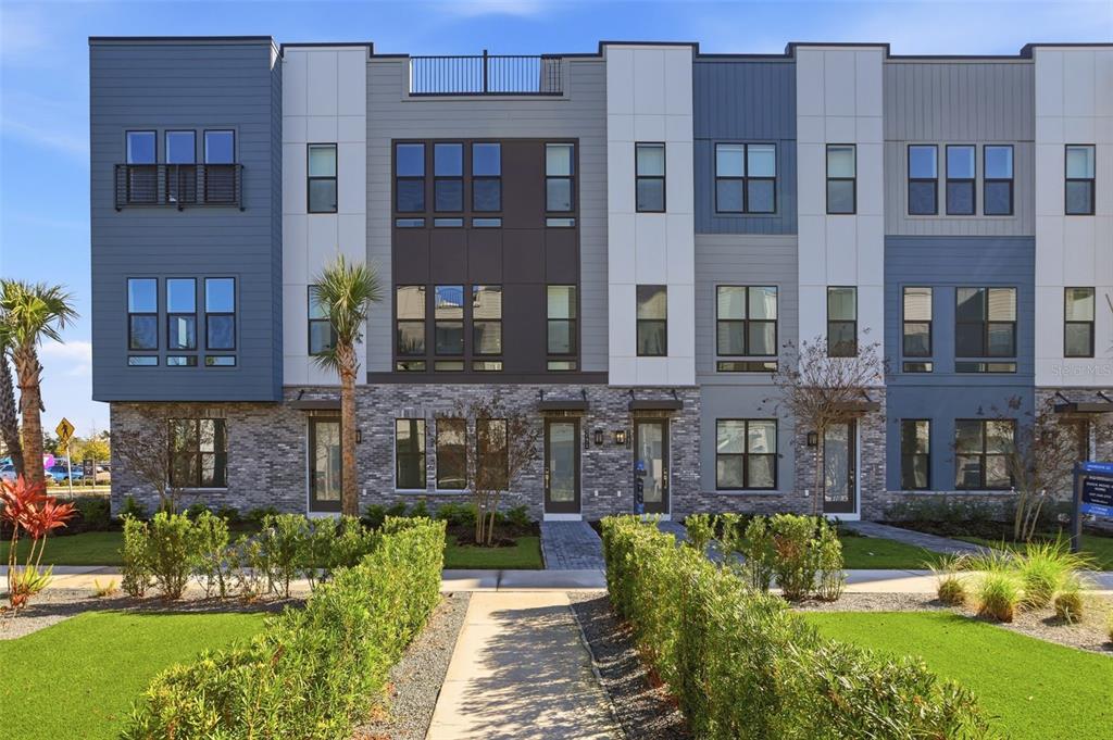 2174 Whitney Marsh Alley Orlando, FL 32804 - Photo 2 of 50 a view of a building with a garden