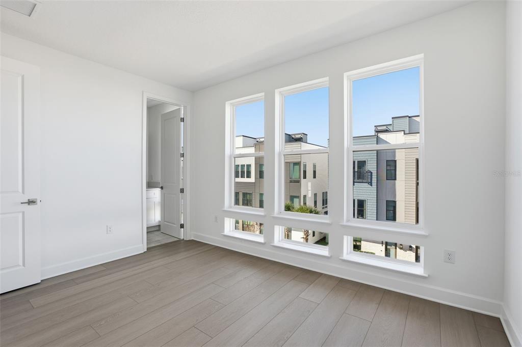 2174 Whitney Marsh Alley Orlando, FL 32804 - Photo 25 of 50 a view of an empty room with wooden floor and a window