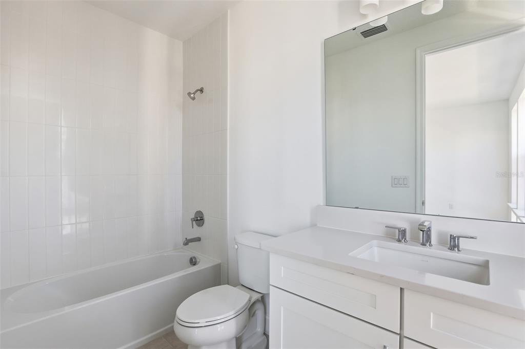 2174 Whitney Marsh Alley Orlando, FL 32804 - Photo 26 of 50 a bathroom with a granite countertop sink toilet a mirror and shower