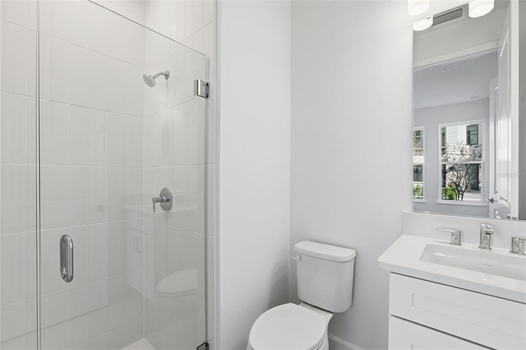 2174 Whitney Marsh Alley Orlando, FL 32804 - Photo 6 of 50 a bathroom with a toilet sink vanity and shower