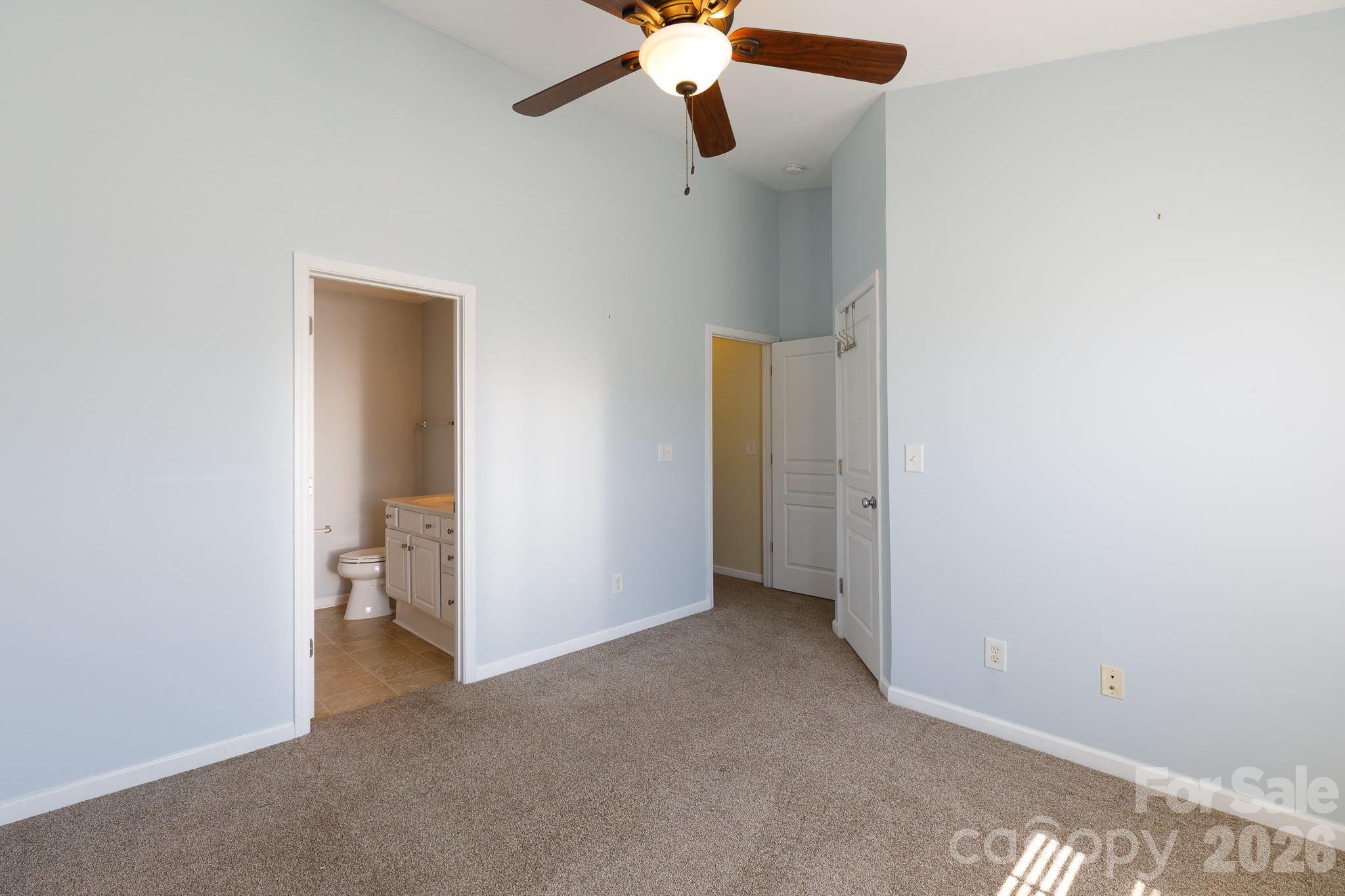 824 Gentlewinds Court Fort Mill, SC 29708 - Photo 11 of 30 an empty room with closet and a chandelier fan