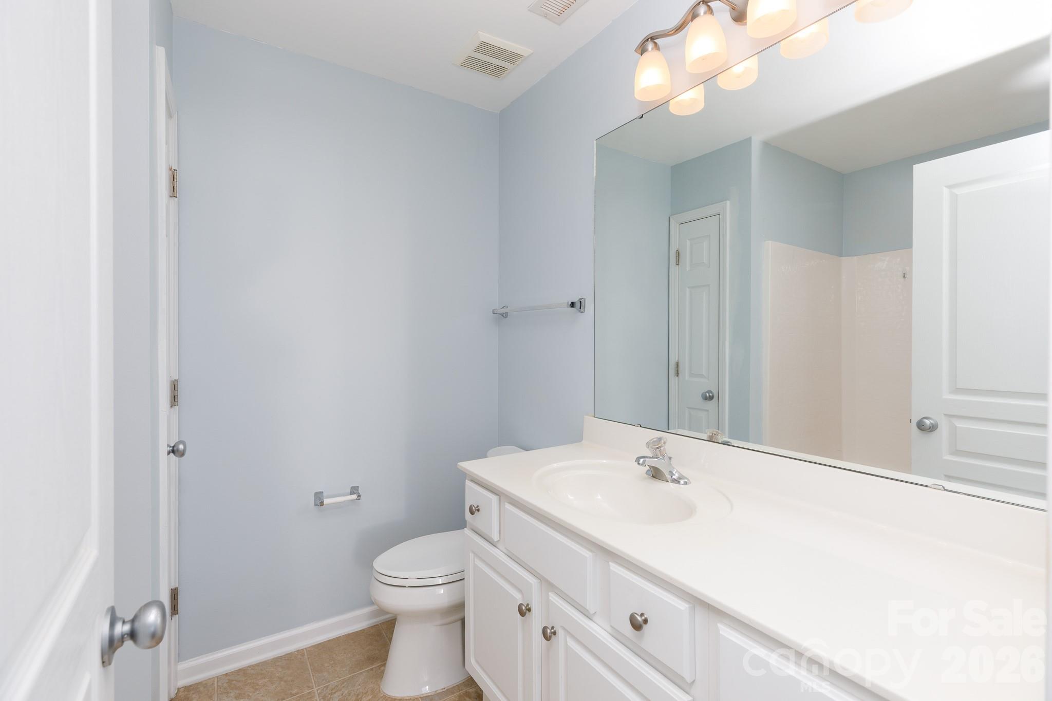 824 Gentlewinds Court Fort Mill, SC 29708 - Photo 14 of 30 a bathroom with a sink a toilet and a mirror