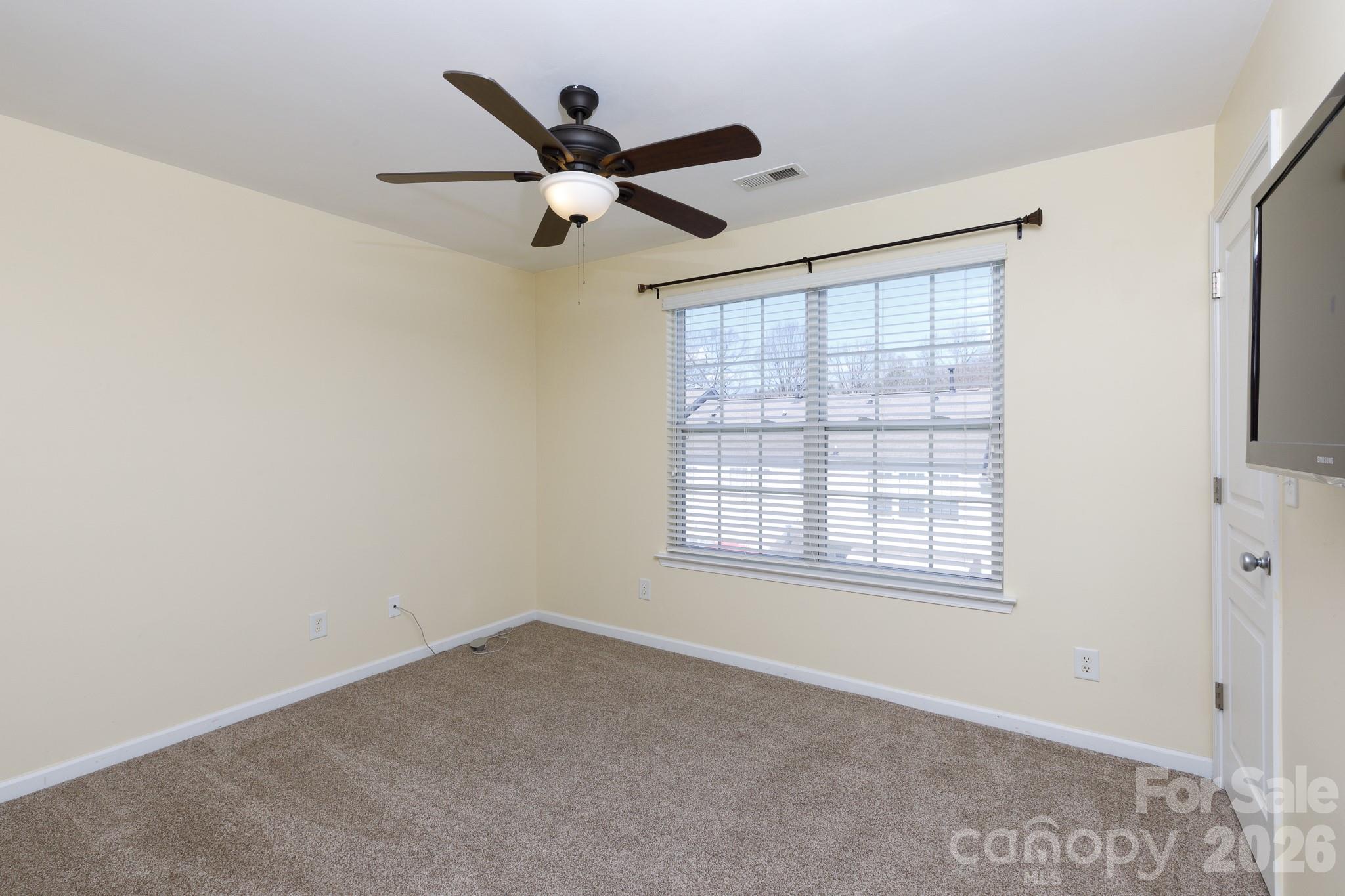 824 Gentlewinds Court Fort Mill, SC 29708 - Photo 17 of 30 an empty room with a window and a fan
