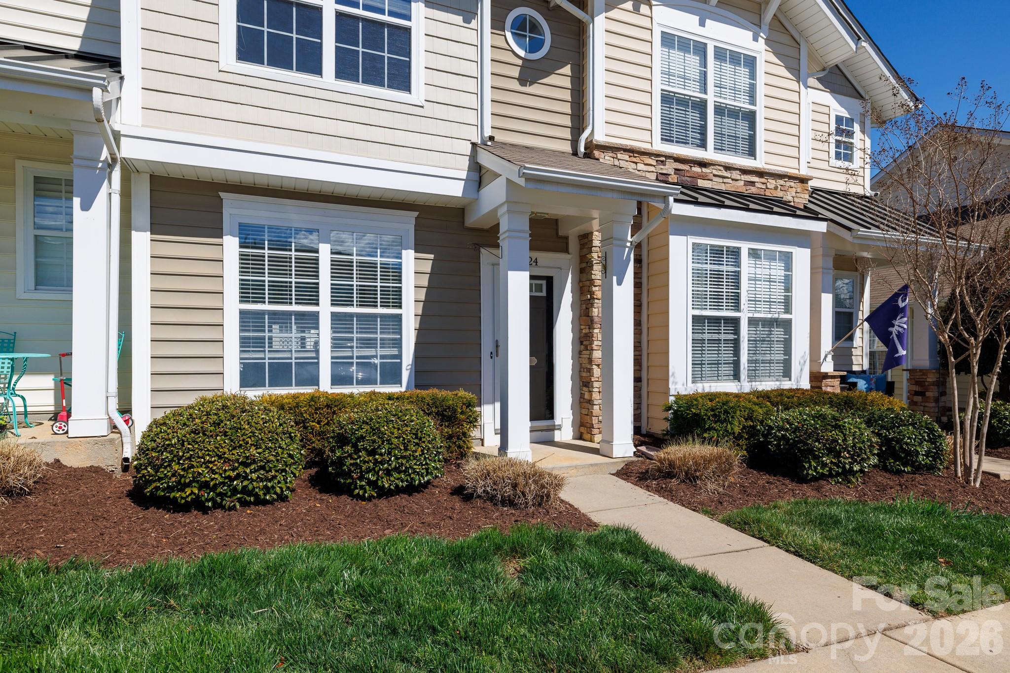 824 Gentlewinds Court Fort Mill, SC 29708 - Photo 2 of 30 a view of a house with brick walls and a yard
