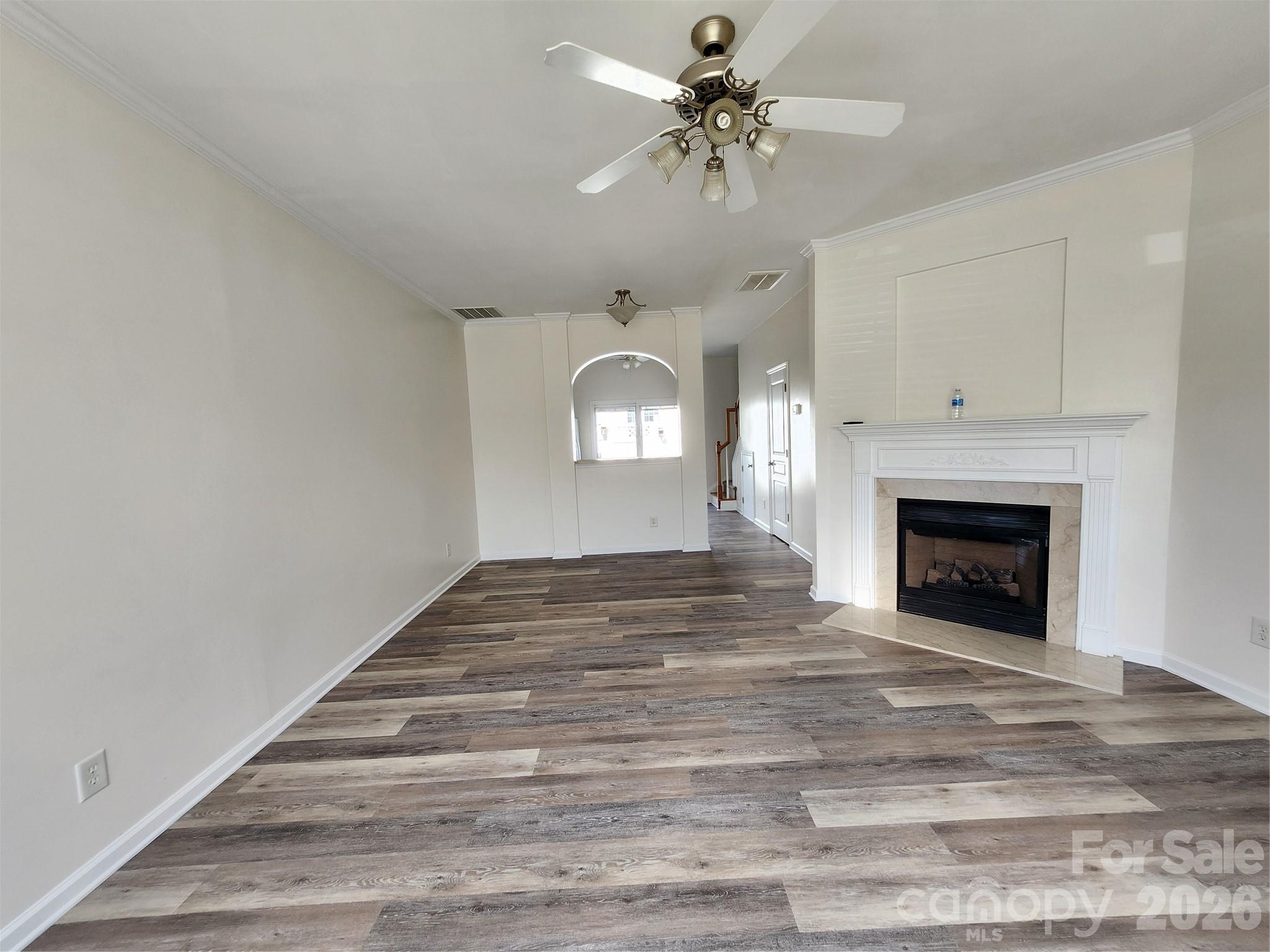 824 Gentlewinds Court Fort Mill, SC 29708 - Photo 5 of 30 a view of a livingroom with a fireplace a ceiling fan and closet area