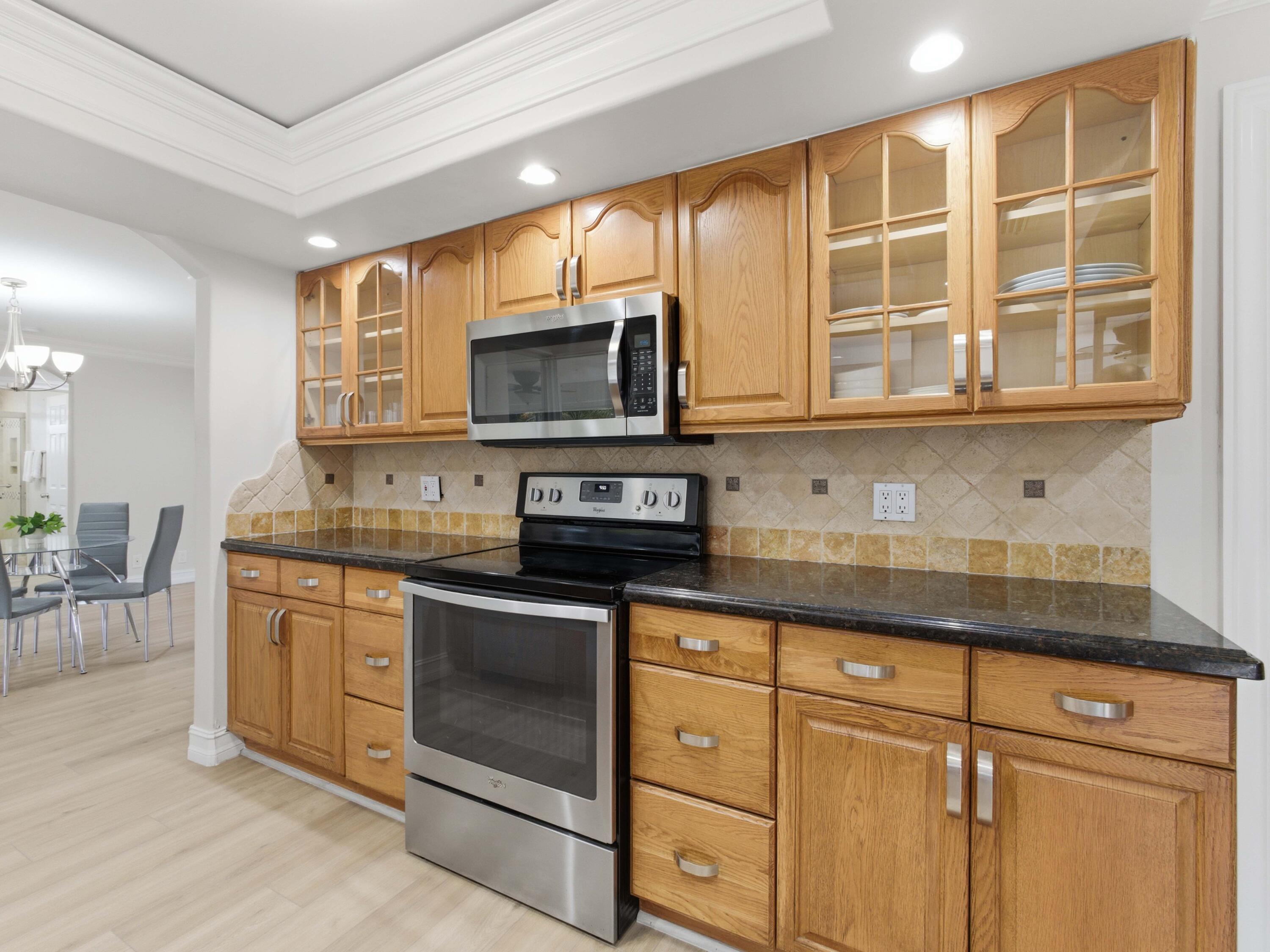 1921 Northeast 28th Court Lighthouse Point, FL 33064 - Photo 15 of 39 a kitchen with granite countertop cabinets stainless steel appliances and a counter space