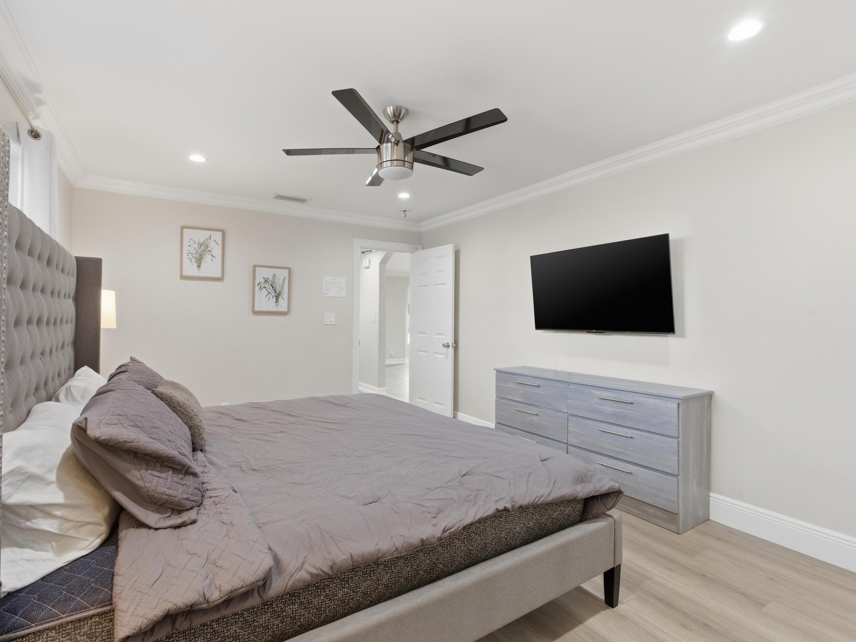 1921 Northeast 28th Court Lighthouse Point, FL 33064 - Photo 20 of 39 a bedroom with a bed and a flat screen tv