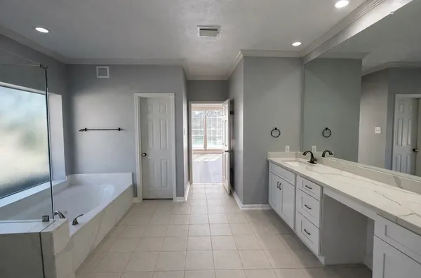 a spacious bathroom with a granite countertop sink mirror and double