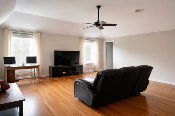 a living room with furniture rug and wooden floor