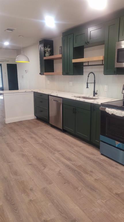 1204 Live Oak Street Commerce, TX 75428 - Photo 12 of 14 a kitchen with stainless steel appliances granite countertop a sink and a stove top oven