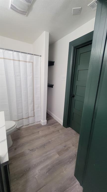 1204 Live Oak Street Commerce, TX 75428 - Photo 4 of 14 a view of a bathroom with a sink and a mirror