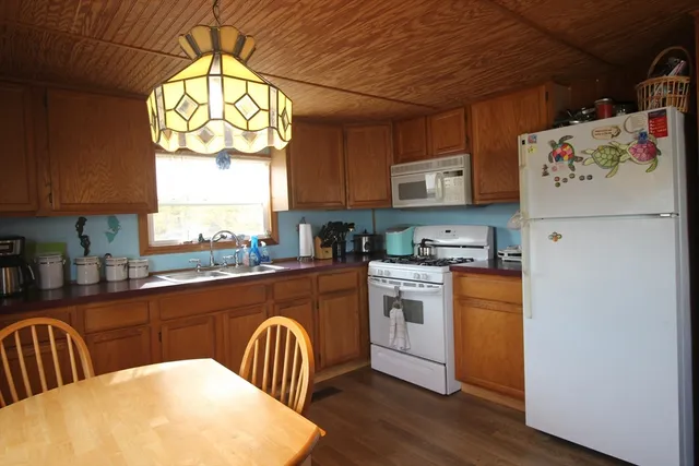 a kitchen with a refrigerator and a window